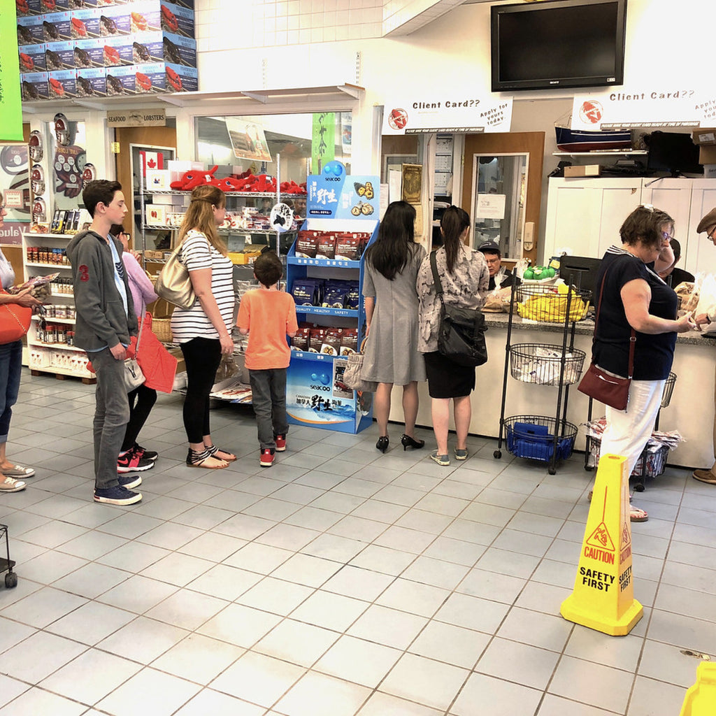 A group of customers at Fisherman's Market waiting in line to buy fresh seafood