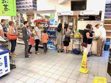 A group of customers at Fisherman's Market waiting in line to buy fresh seafood